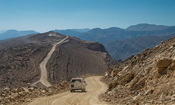 A 4WD driving in the mountains of the interior of the Governorate of Musandam in the north of Oman. This is the dirt road connecting Diba and Khasab through the desert of Musandam. Great road to drive!